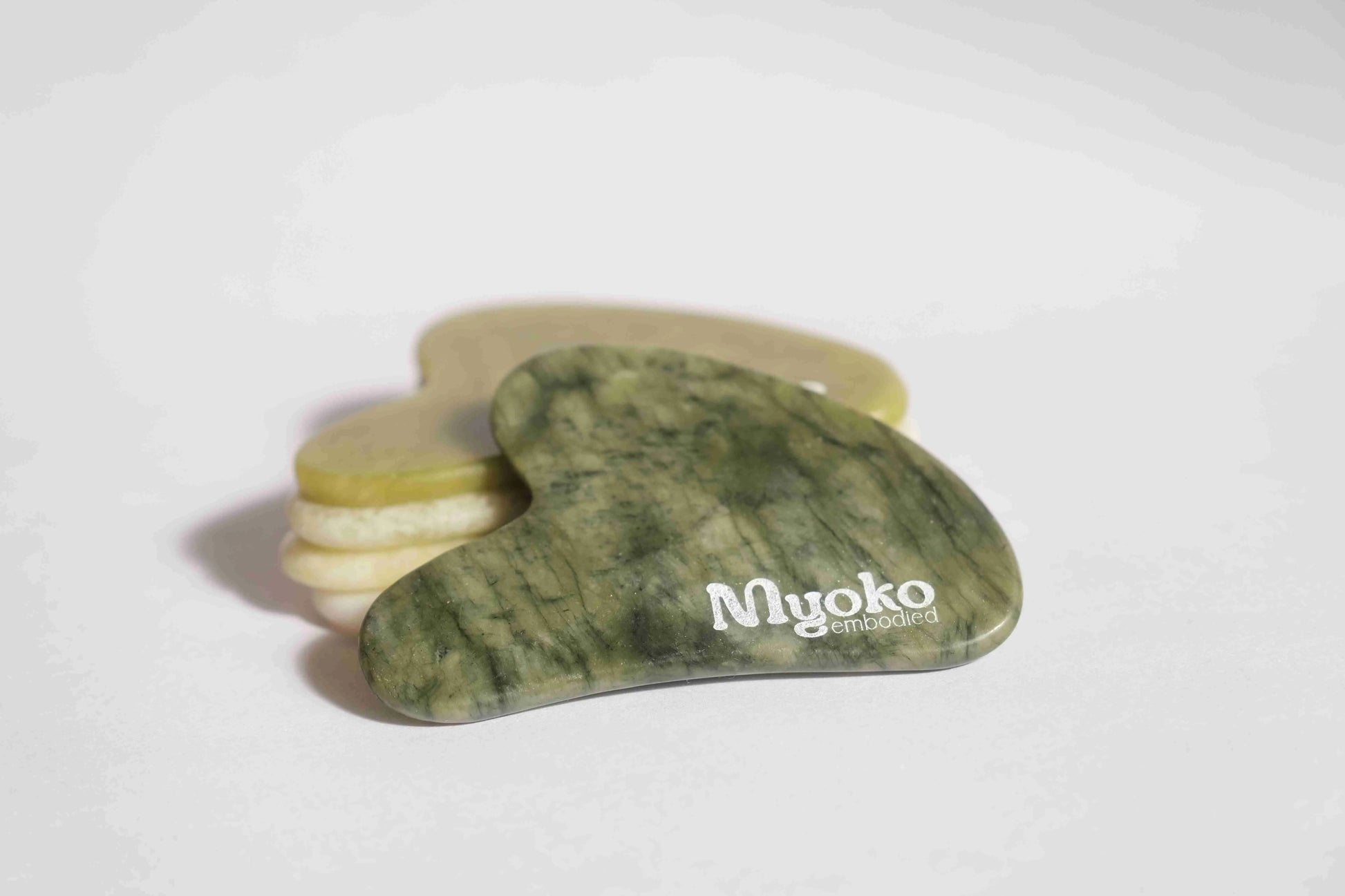 Green stone tool with 'Myoko' branding on a white background