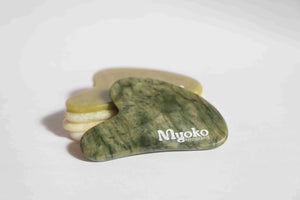 Green stone tool with 'Myoko' branding on a white background