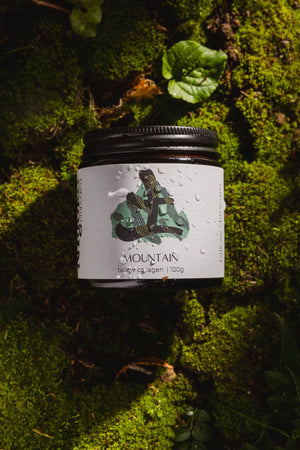 Tallow jar with a label on a mossy background