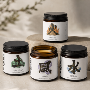 Four jars of tallow with labels featuring nature-themed designs on a neutral background.